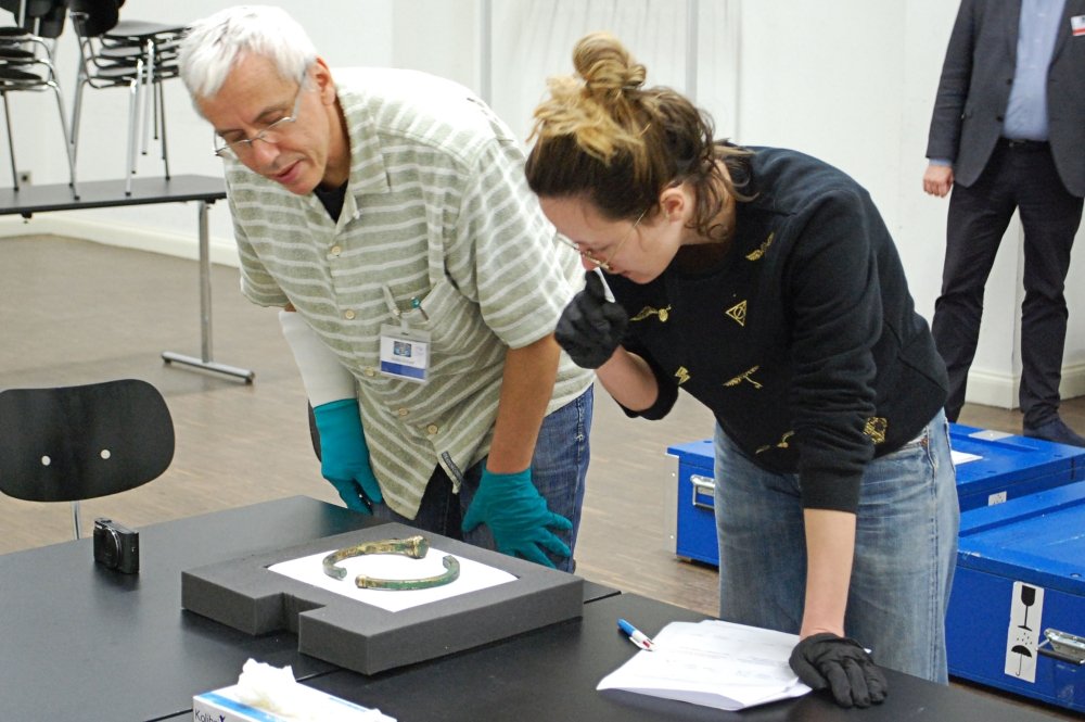 Clémentine Millerat, Kurierin des Musée d'Archéologie nationale in Saint-Germain-en-Laye, prüft gemeinsam mit dem Restaurator des Landesmuseums den Zustand des römischen Torques aus Chassenard (Frankreich). © Landesamt für Denkmalpflege und Archäologie Sachsen-Anhalt.